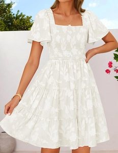 Detail of white square neck floral jacquard dress with ruffled sleeves and tiered skirt