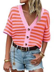 Close-up of pink and orange striped knit texture with brown buttons on a V-neck cardigan