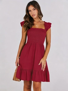 Close-up of square neck dress with ruffled sleeves and elastic smocked chest detail