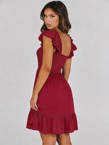 Detail view of the smocked bodice and ruffled straps on this wine red summer dress