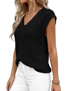 Close-up of black V-neck knitted vest showing detailed chunky knit texture and pattern