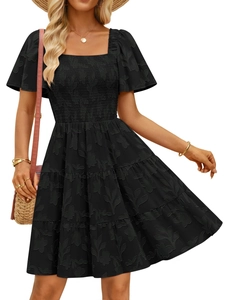Detail of smocked bodice and jacquard floral texture on a black summer dress