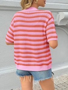 Close-up of pink and orange striped hollow-out knit cardigan showing texture and fit