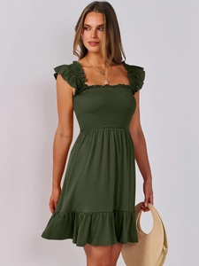 Detail of smocked bodice and square neckline on dark green plaid summer dress