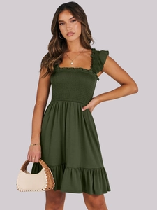 Detailed view of the smocked square neck and ruffled shoulder straps on a dark green dress