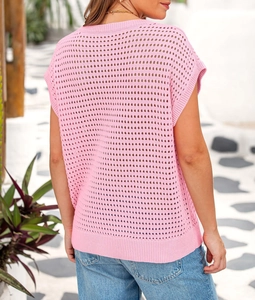 Detail of pink hollow-out knit sweater with intricate crochet patterns from a back view