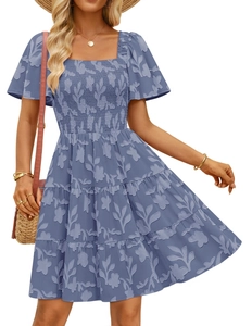 Detail of light blue floral dress with smocked square neck and textured fabric