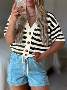Detail of V-neck striped knit cardigan featuring textured fabric and dark buttons