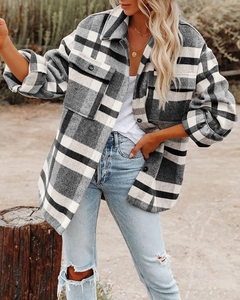 Detail of the black and white plaid flannel shacket featuring large chest pockets and buttons