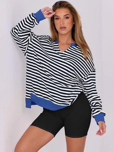 Close-up of blue and white striped sweatshirt featuring a V-neck and ribbed cuffs
