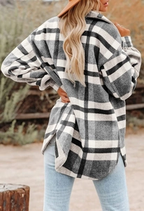 Rear view of women's oversized plaid flannel shacket with curved split hem and drop shoulders