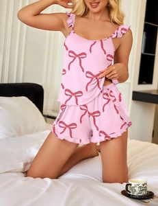Detailed view of pink bow print pajamas featuring delicate ruffle trim and soft fabric