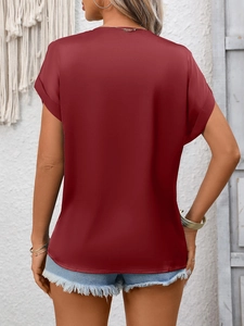 Back view of a burgundy satin V-neck blouse with silky texture and loose-fit short sleeves