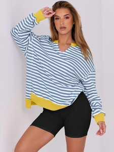 Close-up of blue and white striped sweatshirt with bright yellow ribbed collar details