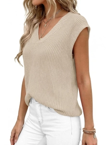 Detailed close-up of apricot chunky knit vest with V-neck and sleeveless texture