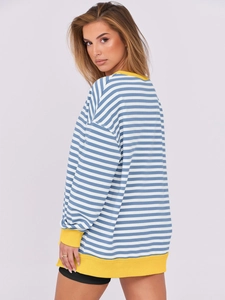 Close-up of blue and white striped sweatshirt featuring bright yellow ribbed cuffs and hem