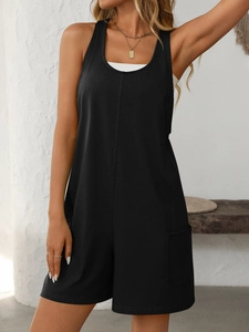 Detail of black sleeveless summer romper featuring large side pockets and middle seams