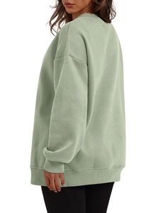Detailed side view of sage green oversized sweatshirt featuring ribbed cuffs and soft fleece
