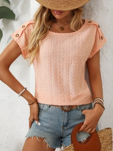 Close-up of peach eyelet short sleeve top with vintage wooden buttons on shoulders