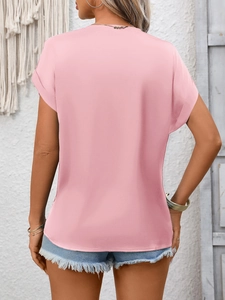 Rear view of pink satin short sleeve top with lace trim and cuffed sleeves
