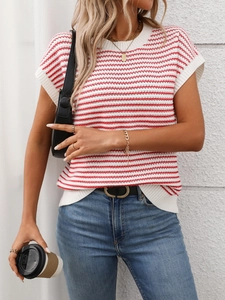 Detail of red and white striped knit top showing round neck and ribbed sleeve cuffs