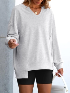Detail of grey V-neck oversized sweatshirt with unique irregular hem and premium knit texture