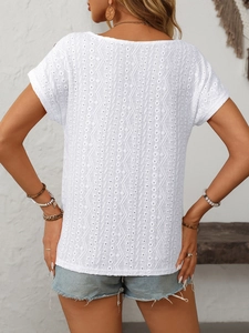 Detail of white hollow embroidery on a casual short sleeve t-shirt for women