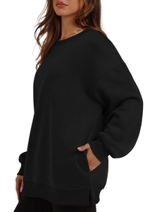 Detail of black crewneck sweatshirt featuring drop shoulders and unique side slit design