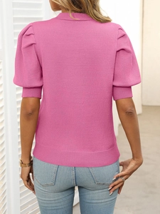 Detail of pink knit short sleeve top showing puff sleeves and ribbed hem from the back view
