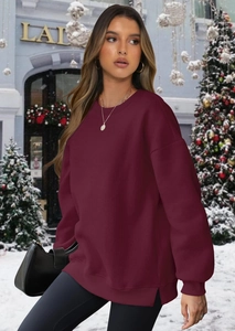 Detail of burgundy crewneck sweatshirt featuring drop shoulders and side split hem design