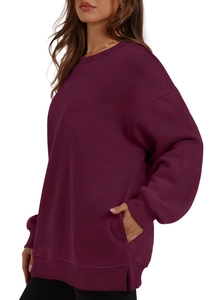 Close-up of oversized burgundy sweatshirt featuring side slits and hidden pockets