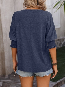 Detailed back view of navy blue textured cotton blouse with elastic ruffled sleeve cuffs