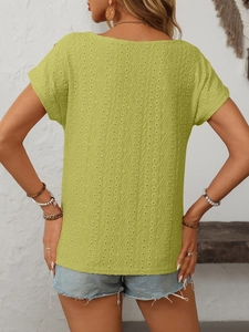 Detail of lime green eyelet embroidery fabric with vertical wavy geometric textures