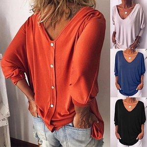 Detail view of women's V-neck top showing functional back button design and loose fit fabric