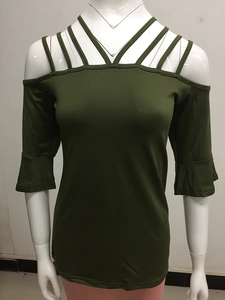 Detail of army green cold shoulder top with crisscross straps and ruffle bell sleeves