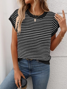 Detail of casual black and white striped knit top with round neck and soft texture