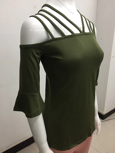 Detail of army green off-shoulder top with criss-cross straps and flared ruffle sleeves