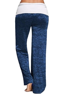 Detail of high-waist white fold-over waistband on dark blue yoga flare pants
