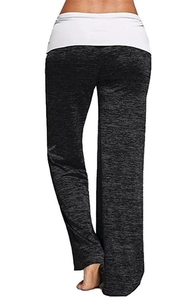 Detail of black heather yoga pants showing the white fold-over waistband and wide leg cut