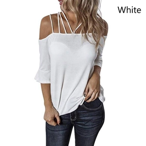 Detail of off-shoulder white top featuring multi-strap crossover design and bell sleeves