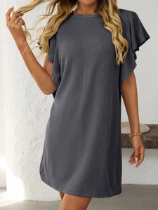 Detail of grey knitted dress featuring flutter sleeves and waffle texture fabric