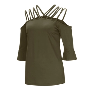 Detail of olive green cold-shoulder top with criss-cross straps and elegant flared cuffs