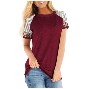Detail of burgundy T-shirt showing striped and leopard print patchwork on short sleeves