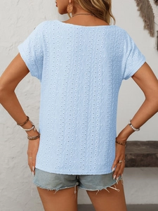 Detail view of light blue eyelet embroidery fabric on a short sleeve casual summer top