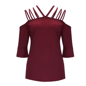 Detailed view of cage cold shoulder neckline on wine red bell sleeve knit top