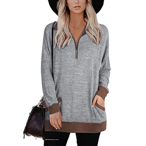 Vue détaillée du sweat gris à manches longues avec demi-zip et bordures contrastées