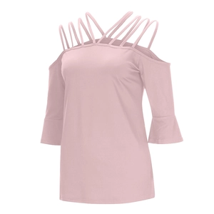 Detail of light pink cold shoulder top with crisscross straps and bell sleeves