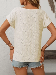 Outdoor back view of cream eyelet short sleeve t-shirt with cutout geometric patterns