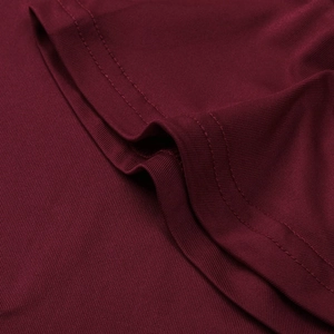 Detailed close-up of double-stitched hem on burgundy knit long sleeve t-shirt