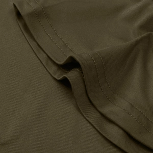 Macro shot of olive green knitted fabric with professional double-stitched hem details